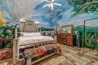 furnished domed room with colorful murals