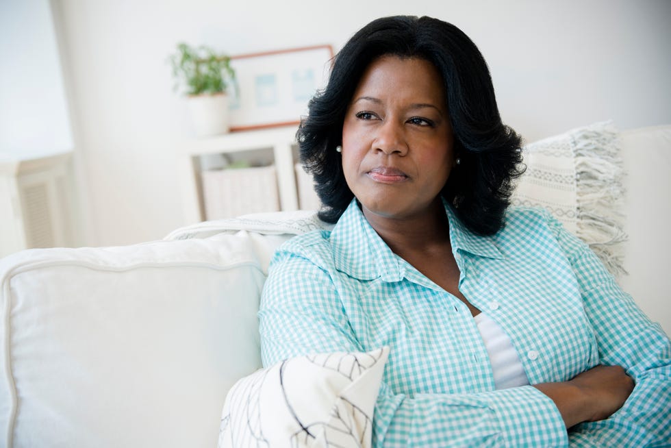 midlife crisis signs  woman sitting on sofa