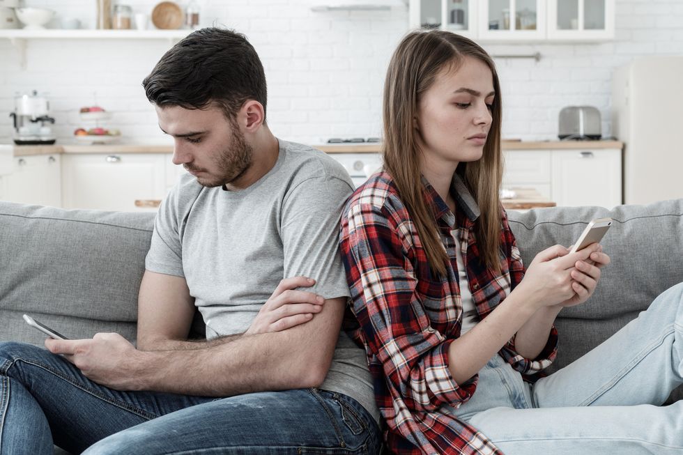 unhappy couple ignoring each other using mobile phones boyfriend and girlfriend with smartphone addiction bad relationship concept