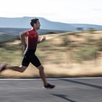 uniformed triathlete in sportswear 45 years old running