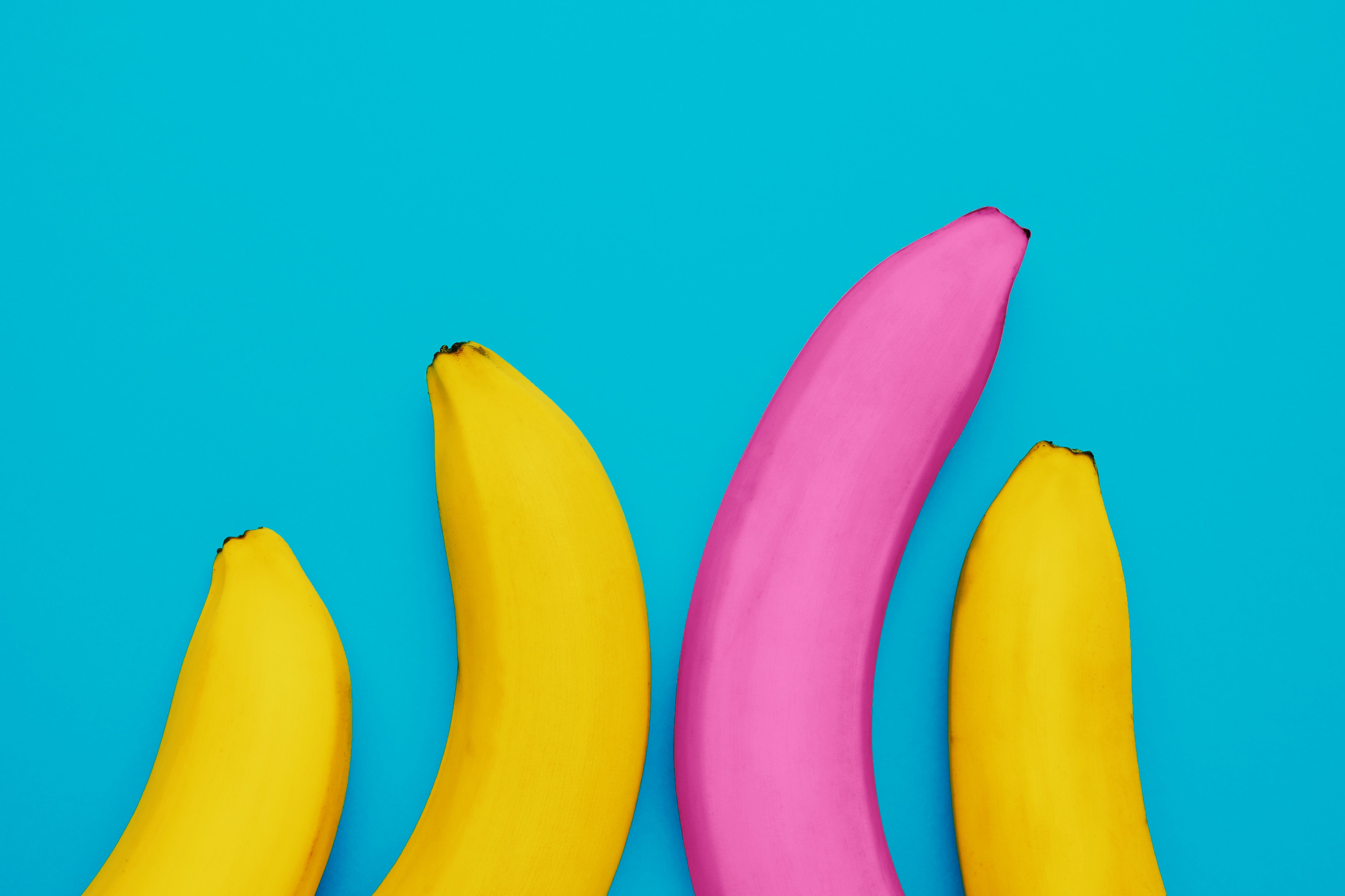 a unique pink banana among the yellow ones as a concept for a male penis provocatively large size, potency and prostate problems choosing the perfect lover