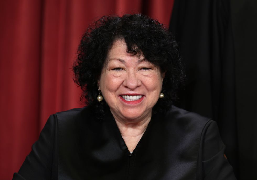 sonia sotomayor wearing her supreme court clothing and smiling for a photograph