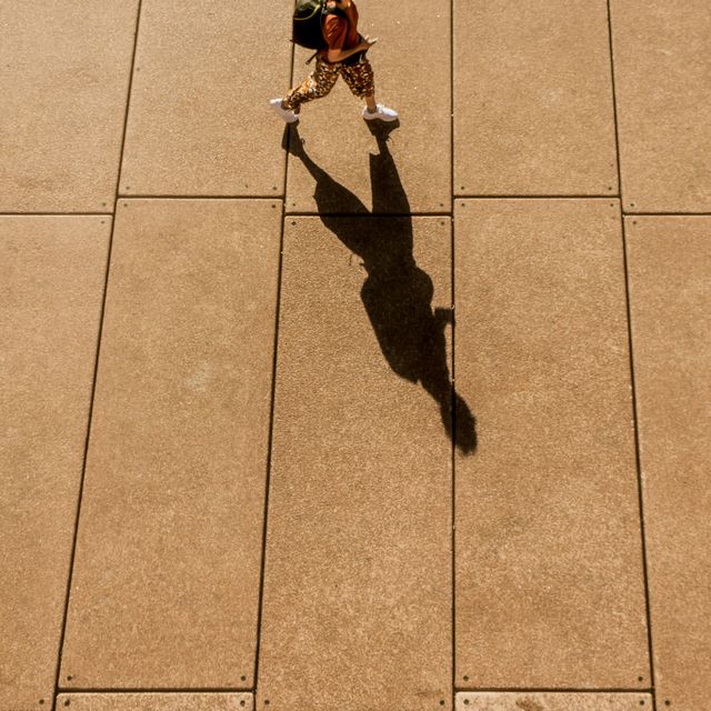 a high angle view of a long shadow of a person walking in sydney city