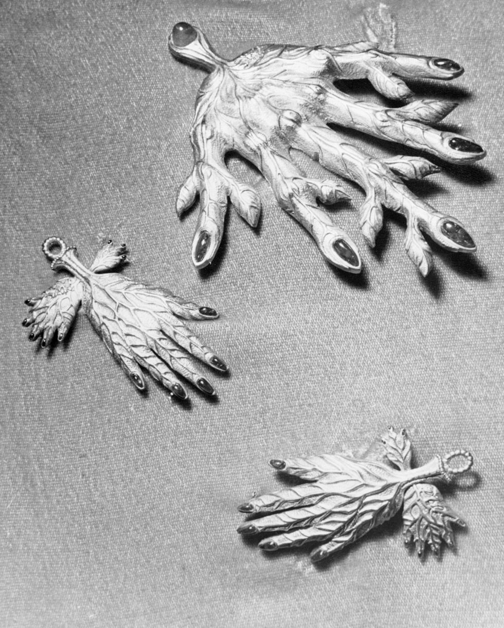 during the next two weeks, parisians will have an opportunity of viewing a collection of objets d'art and and jewels designed by salvador dali they are being presented by the catherwood foundation of bryn mawr some of the items included in the collection are these leaf veined hands made of sculptured gold, rubies and emeralds