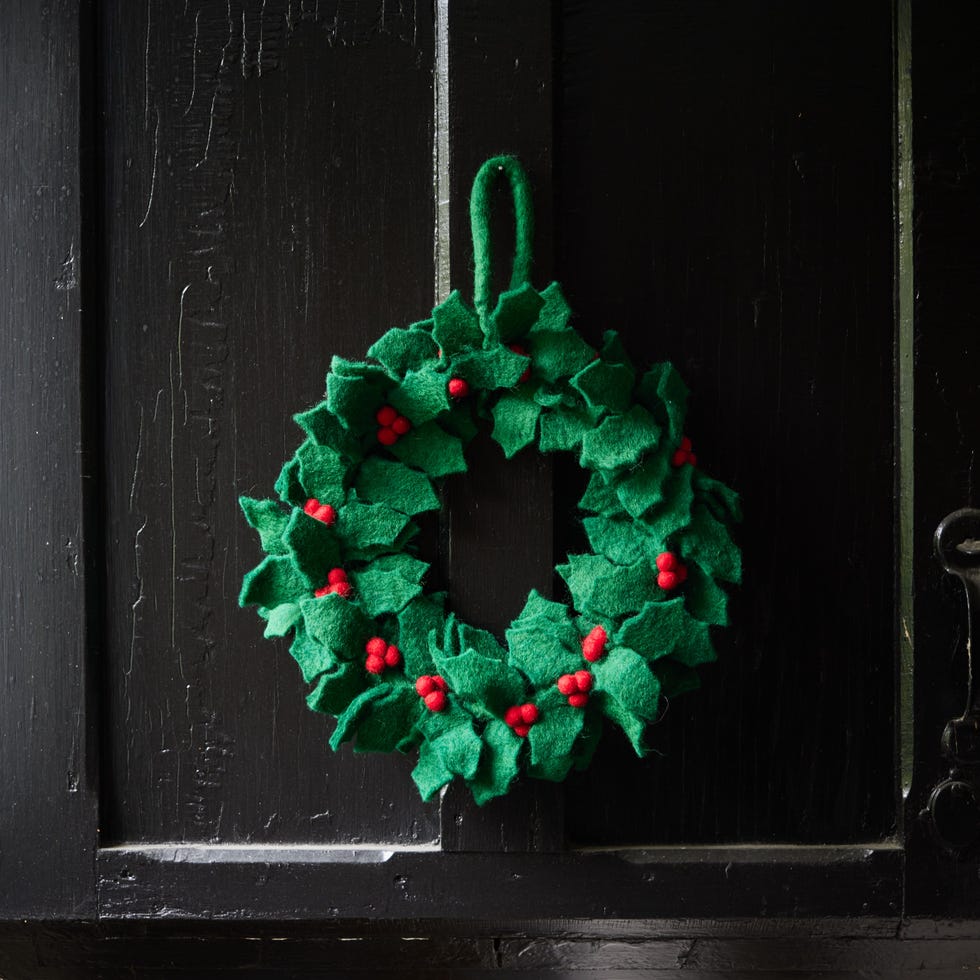 Black door with a small felt wreath