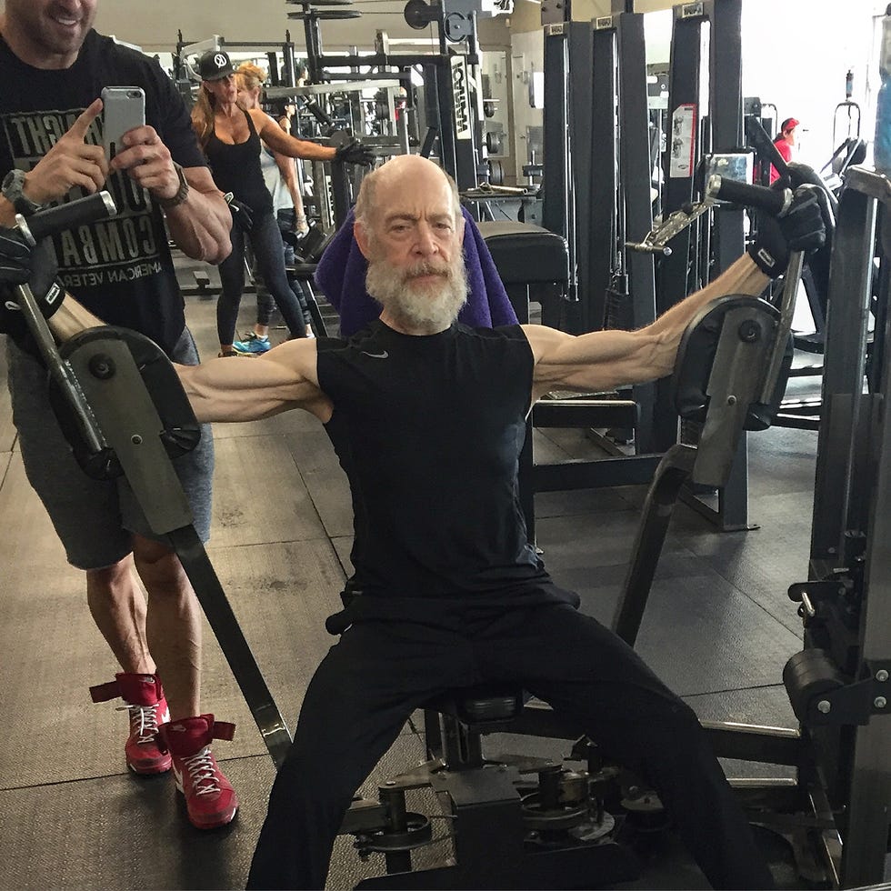 Gym scene with individuals lifting weights and exercising