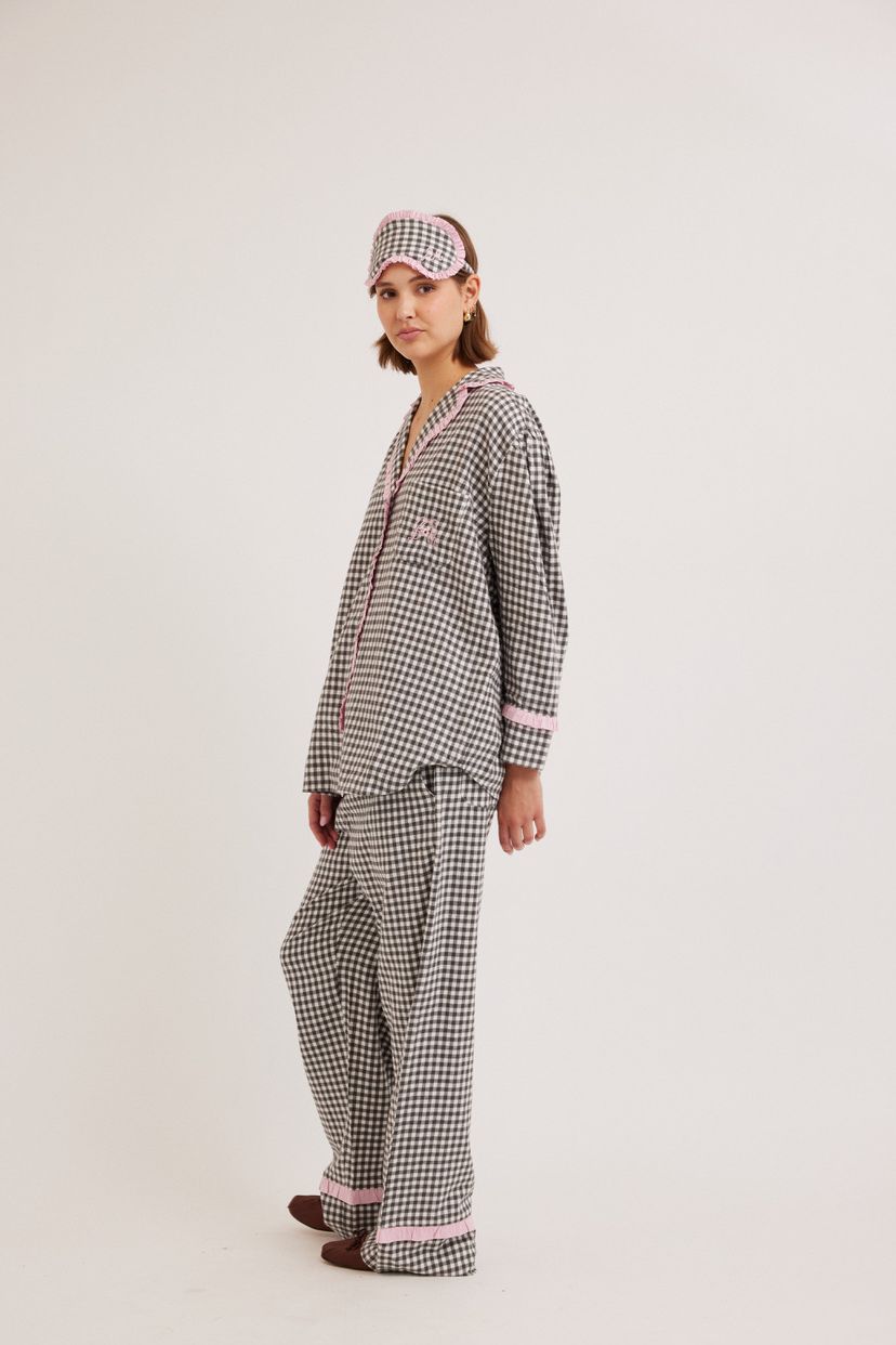 woman wearing gingham pyjamas