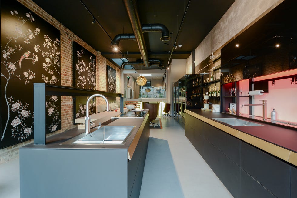 a large kitchen with a bar and a large brick wall