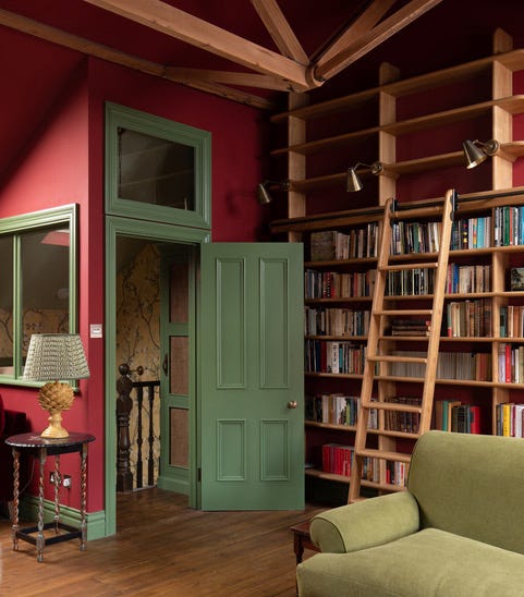 cozy reading nook with a green door leading to another room and a bookshelf cozy reading nook with a green door leading to another room and a bookshelf