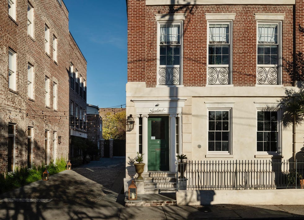 a brick building with a green door