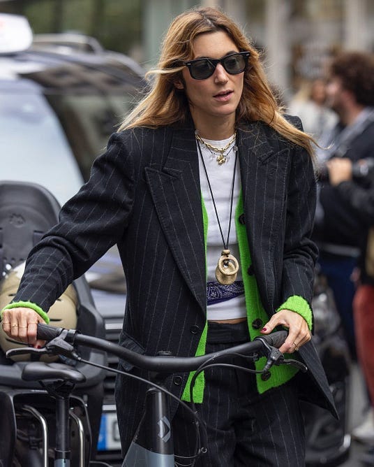 fashionable individual riding a bicycle