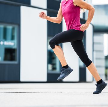 unrecogniseable woman jogging running in modern city
