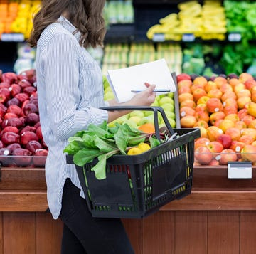 woman shops for produce in supermarket