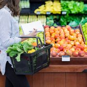 Unrecognizable woman shops for produce in supermarket