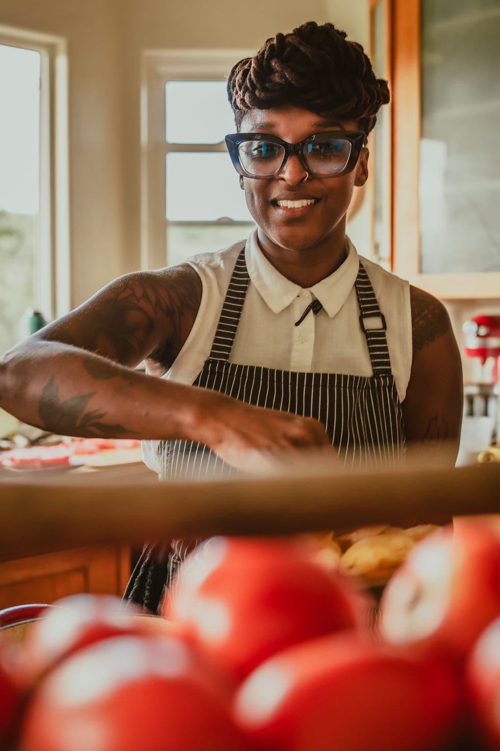 mariya moore russell smiling with tomatos