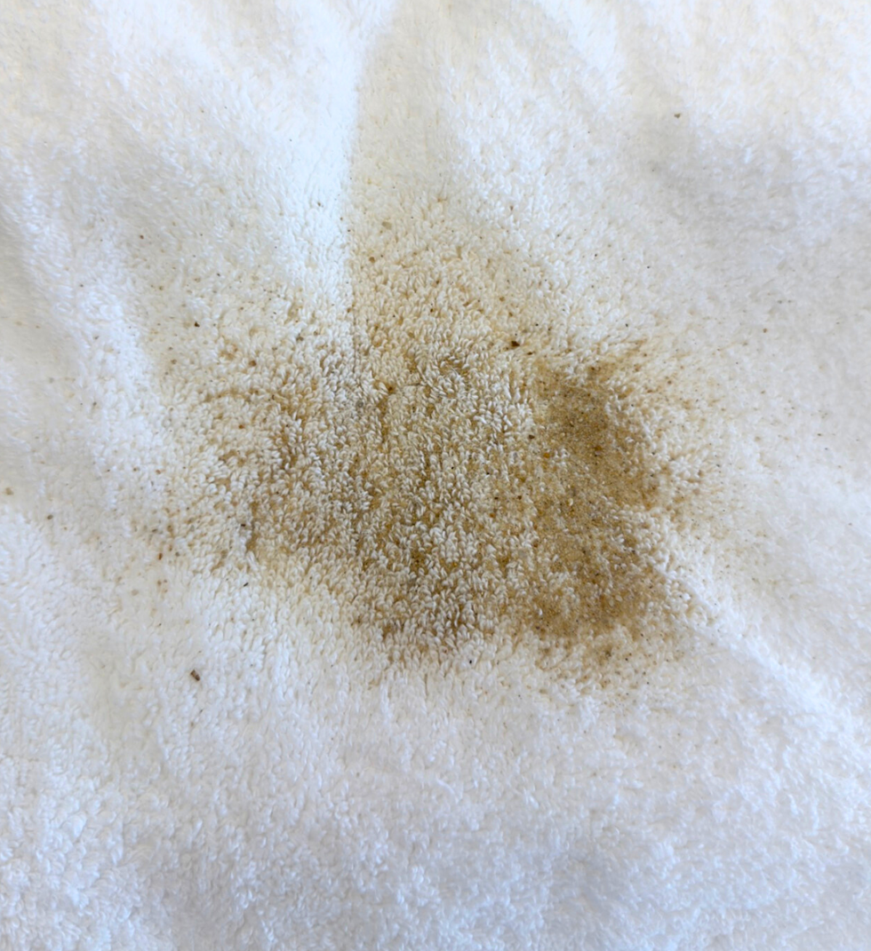 a close up of sand poured onto a terrycloth towel