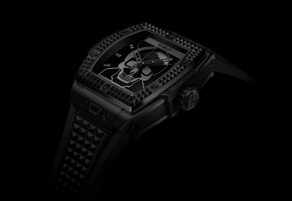 a silver watch with a black background