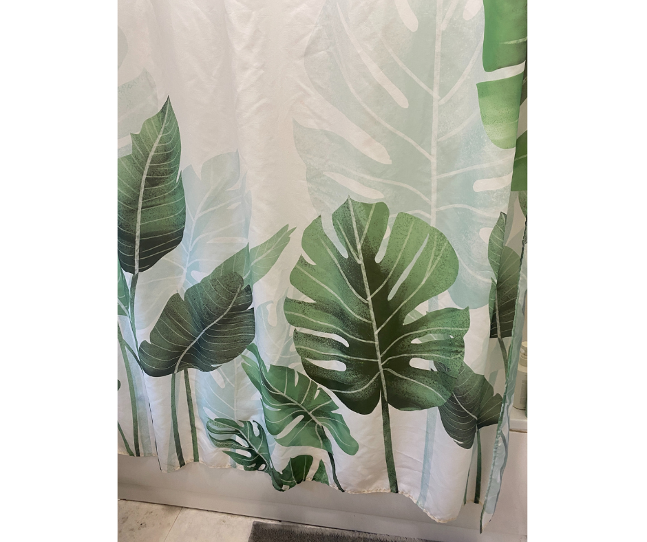 floral shower curtain featuring various green tropical leaves