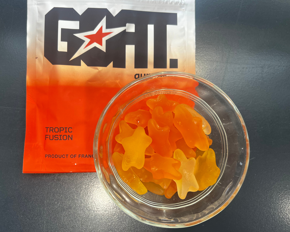 orange colored gummies in glass bowl with packaging