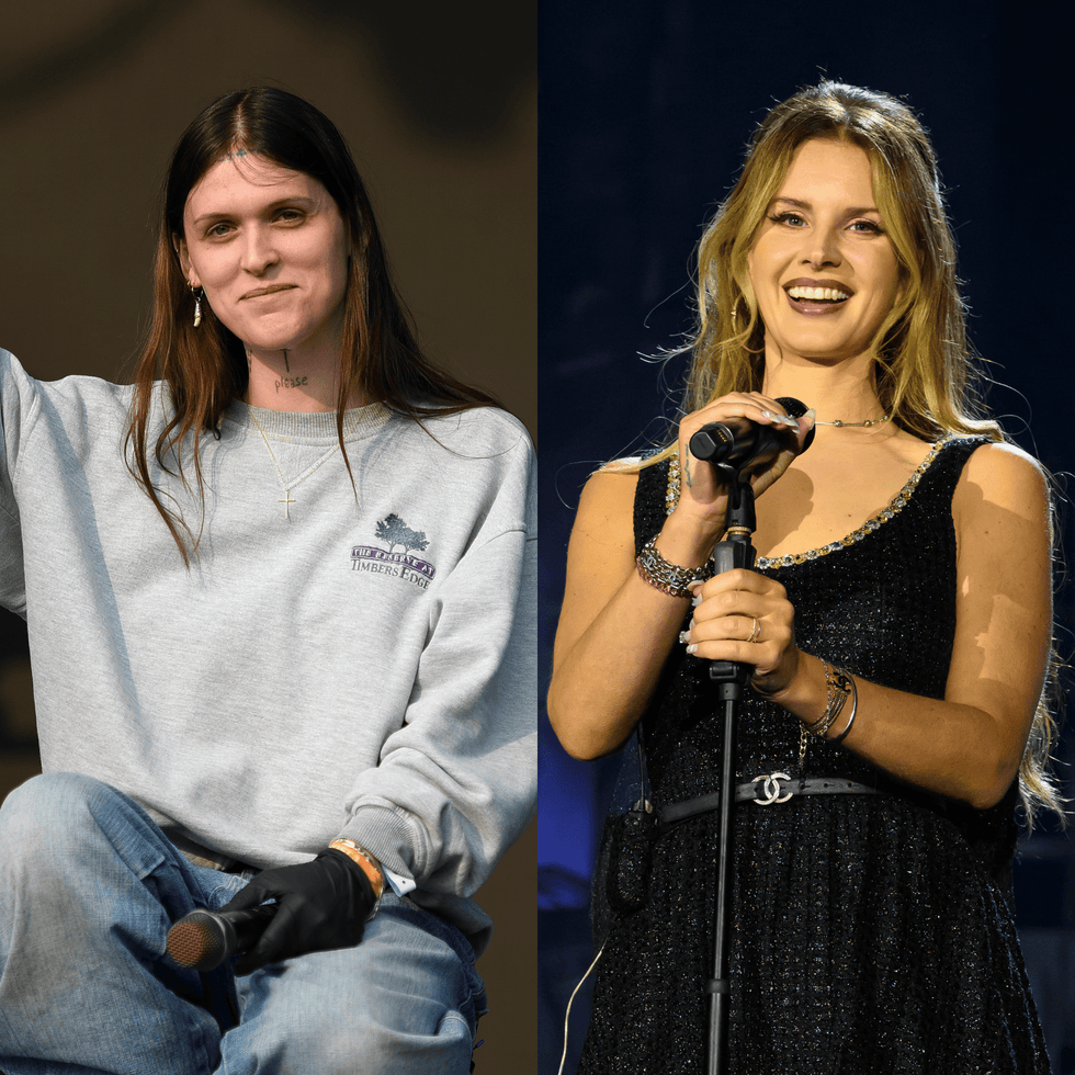 two women performing on stage one seated and one singing with a microphone