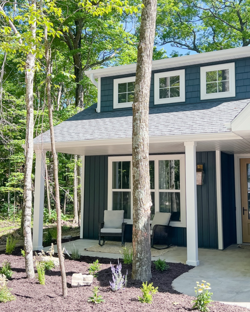 modern house entry with porch and surrounding greenery