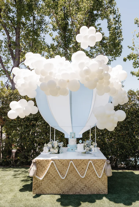 up and away baby shower theme with hot air balloon and cloud balloons
