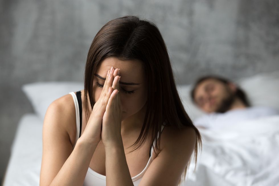 upset frustrated woman feeling troubled while boyfriend sleeping