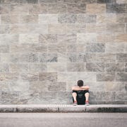 urban exhausted fitness man outdoor sitting on the floor