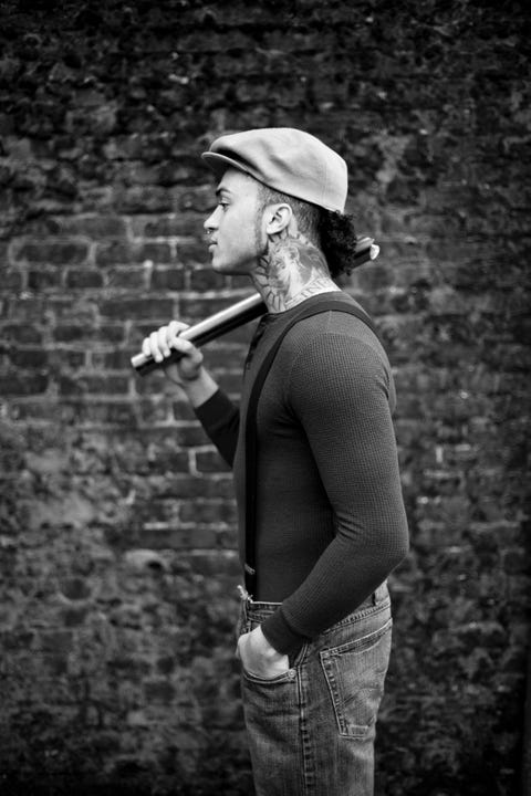 urban hipster holding metal pipe profile portrait