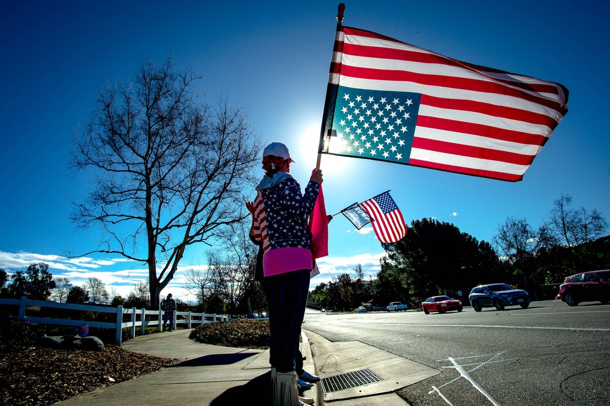 temecula, ca   january 20 joan galt holds an upside down american flag, a signal of distress, as conservative activists protest during the save america rally at the duck pond in temecula on wednesday, jan 20, 2021 as joe biden is sworn in as the 46th president of the united states photo by watchara phomicindamedianews groupthe press enterprise via getty images