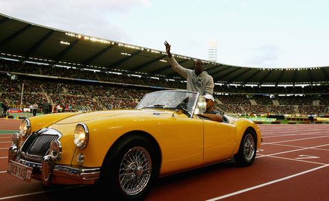 Usain Bolt riding in convertible