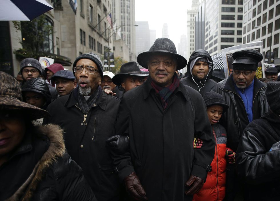 chicago, il   november 27 us representative bobby rush and reverend jesse jackson link arms as they march with demonstrators protesting the shooting of laquan mcdonald who was killed by a chicago police officer along the michigan mile also know as the magnificent mile november 27, 2015 in chicago, illinois chicago police officer jason van dyke was charged tuesday with first degree murder for fatally shooting 17 year old mcdonald 16 times last year on the southwest side of chicago after van dyke was responding to a call of a knife wielding man the dash cam video of officer van dyke shooting mcdonald was released by the chicago police department earlier this week after a judge denied van dyke bail during his bond hearing at leighton criminal court photo by joshua lottgetty images