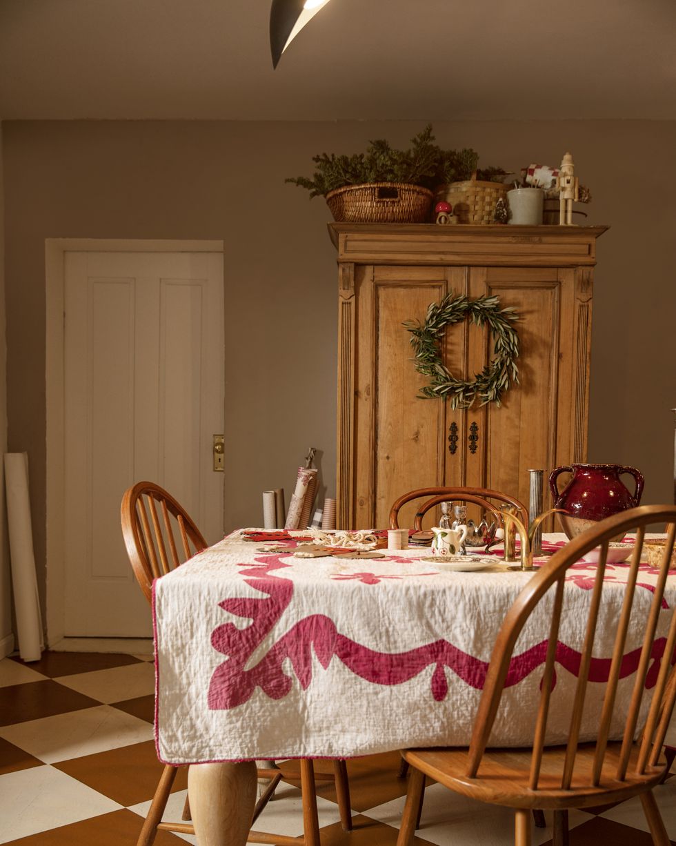 'tis a gift to be simple homeowners merrilee liddiard and jon liddiard outfitted with a simple olive wreath, the dining room’s pine armoire houses dishes, linens, and craft supplies dining room, christmas decor, christmas wreath