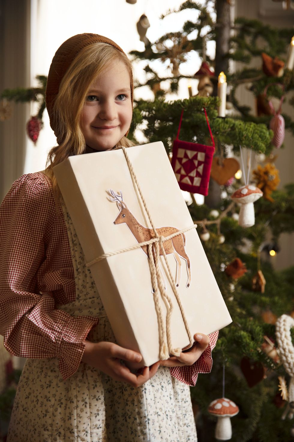 'tis a gift to be simple homeowners merrilee liddiard and jon liddiard merrilee adorns brown paper packages with illustrations like this reindeer christmas craft, holiday decor