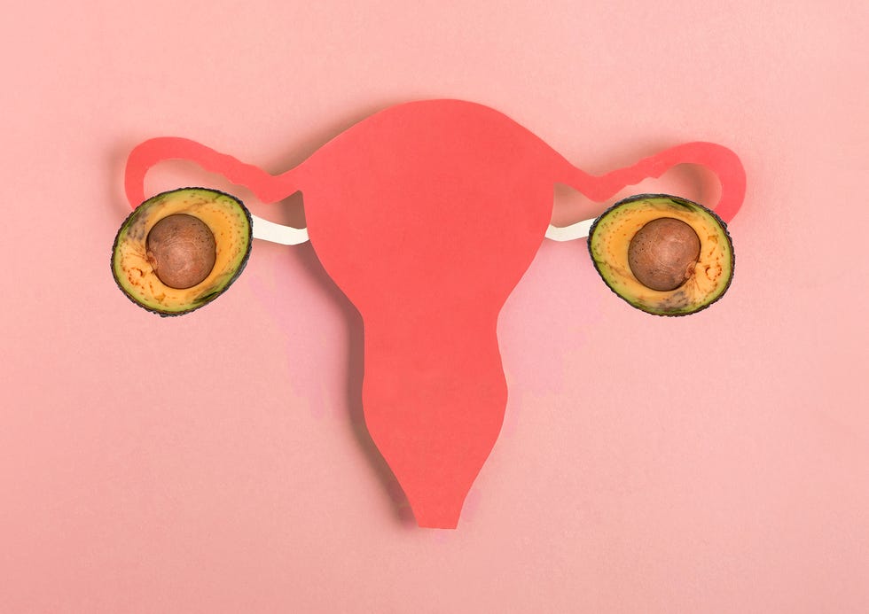 decorative model uterus made frome paper on pink background top view, copy space