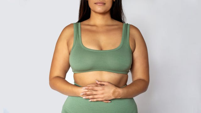 midsection shot of a woman in underwear on white background