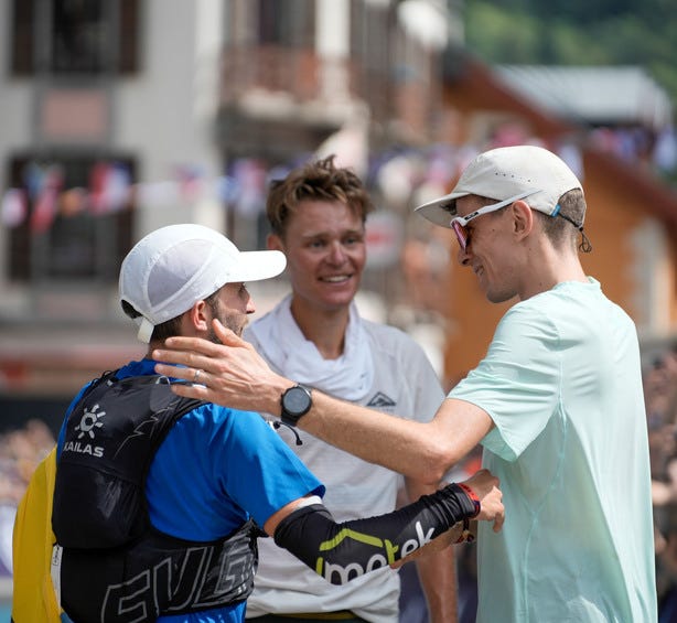 the top three men embrace at the end of the 2024 utmb