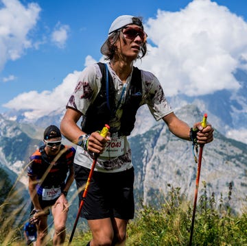 two trail runners hiking through the mountains at the utmb two trail runners hiking through the mountains at the utmb