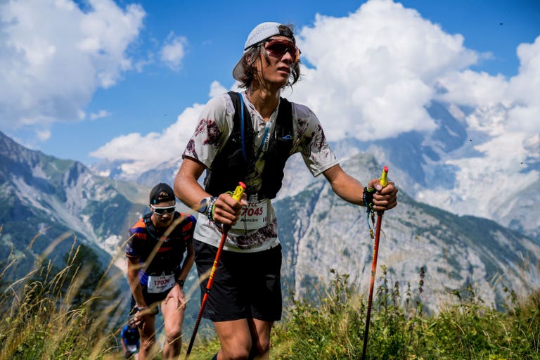 two trail runners hiking through the mountains at the utmb