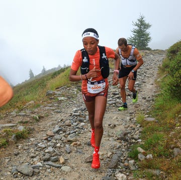 trail runners navigating a rocky path in a mountainous area trail runners navigating a rocky path in a mountainous area
