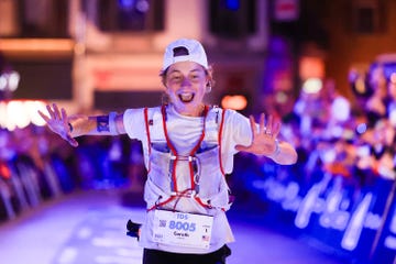 a runner celebrating at the finish line