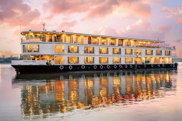 luxury riverboat moored on serene water during sunset
