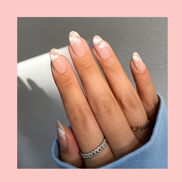 one hand in a pink border with pink nails and little white clouds and another hand on the right with pink, gray, and maroon french tips and little hearts on each nail for valentine's day