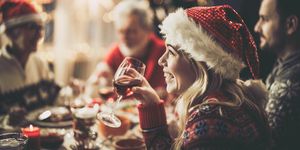 een vrouw drinkt een wijntje bij het kerstdiner