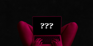a woman holding a laptop in her lap with question marks on the screen