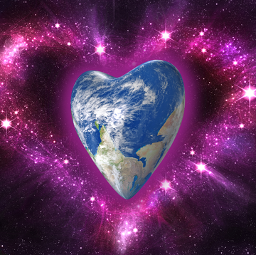 a glitter heart surrounds a heart shaped planet earth