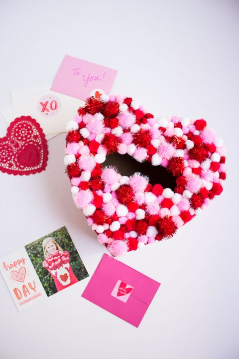 heart shaped valentine's day box covered in red, pink, and white mini pom poms