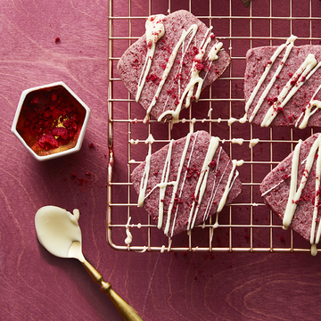 pink valentines day cookies with white chocolate drizzled on top
