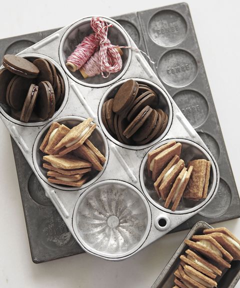 bittersweet chocolate sandwich cookies with raspberry preserves arranged in the cavities of a muffin tin