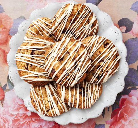 coffee chocolate chunk cookies with white chocolate drizzle on floral background